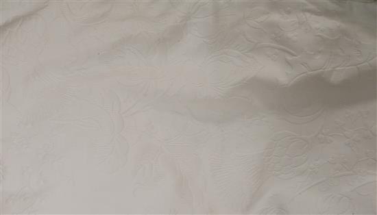 A cream bedspread and table linen